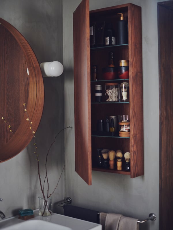 A STOCKHOLM mirror with walnut veneer.