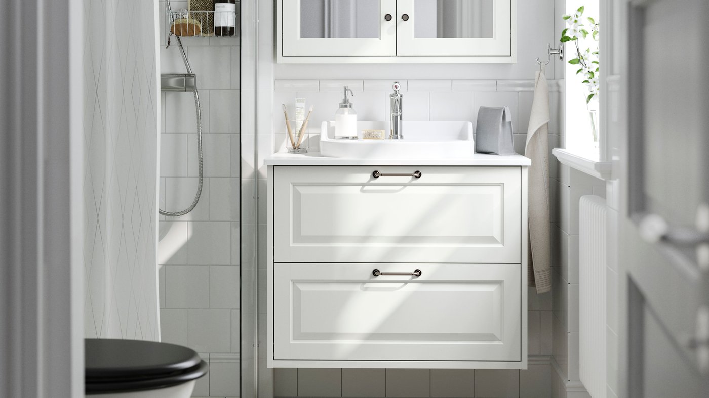 A white/white marble effect RUTSJÖN wash-stnd w drawers/wash-basin/tap in the bathroom