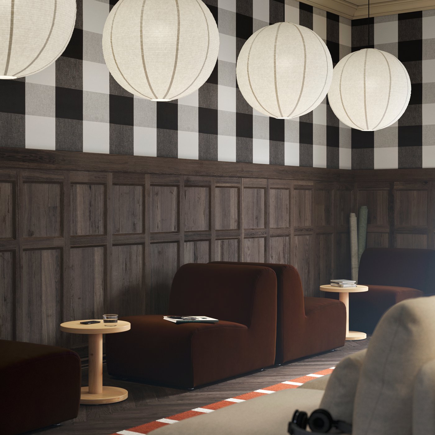 Two dark brown STOCKHOLM seats, paired with pine side tables, with GULLSUDARE pendant lamps hanging from the ceiling.