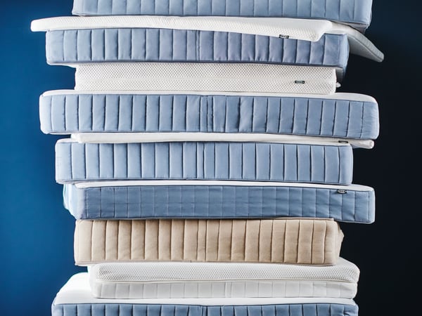 A firm/light blue VALEVÅG pocket sprung mattress