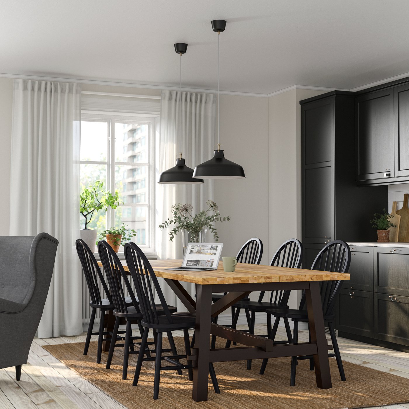 An acacia/black SKOGSTA dining table in the kitchen