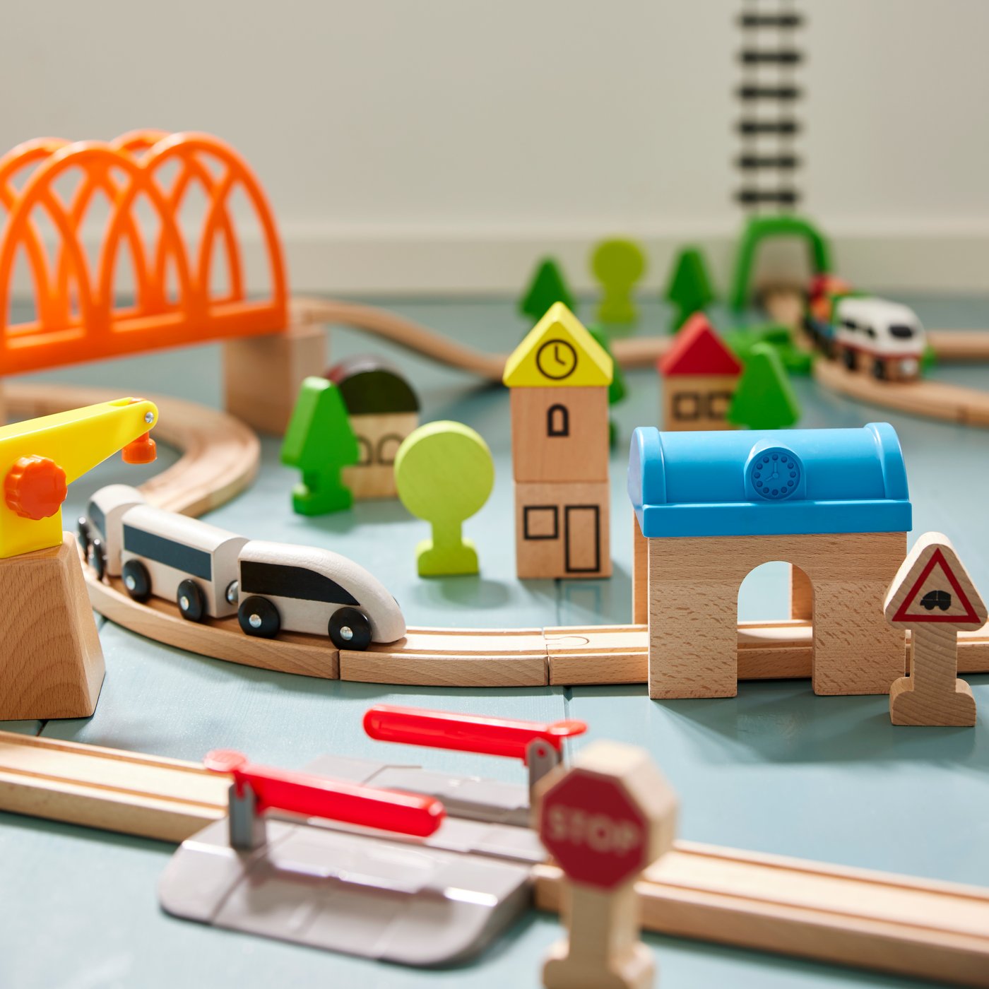 Close-up of LILLABO train set with rails and toy figures.
