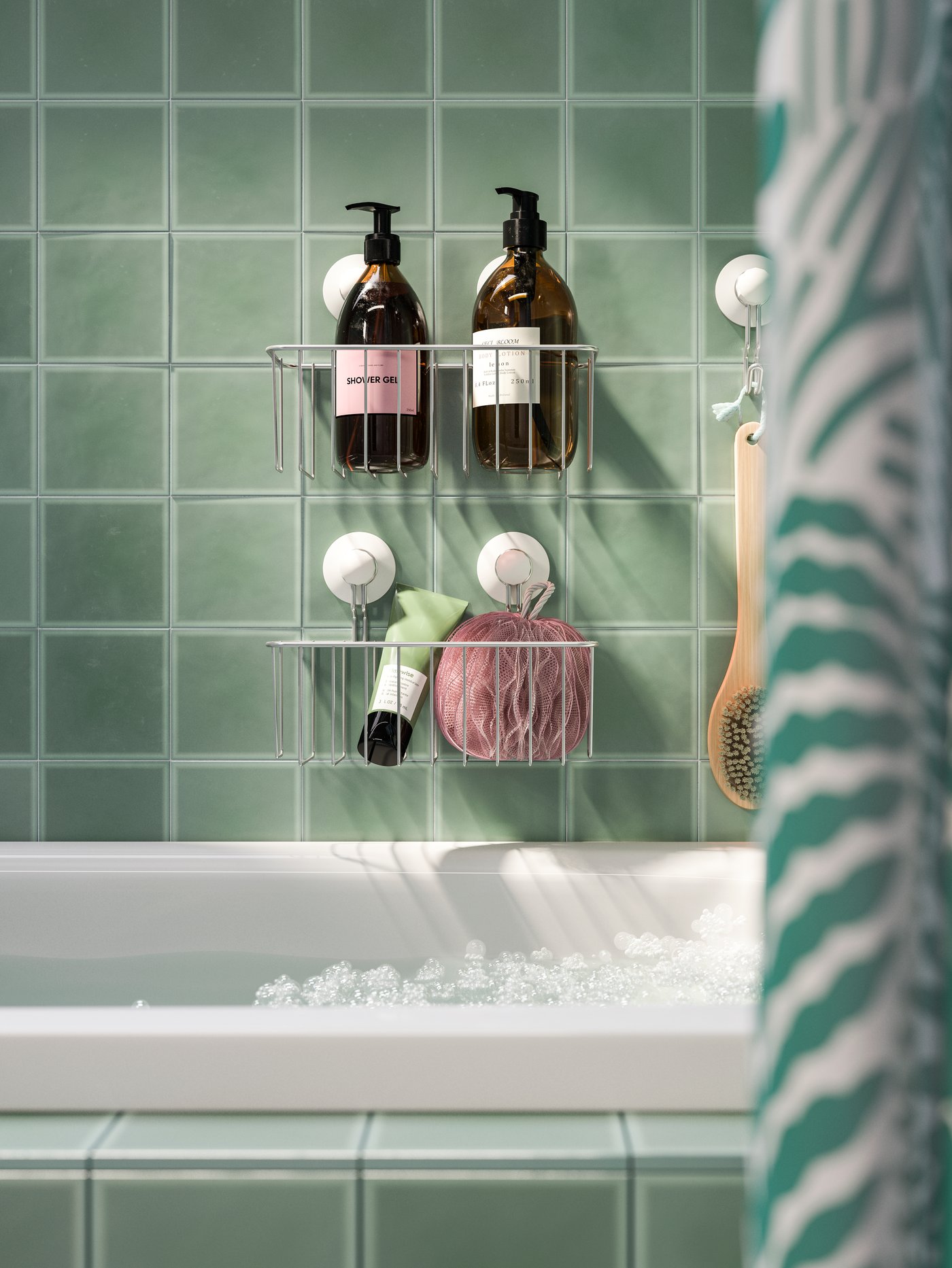 Shower gels and other shower items stored in baskets with suction cups that are attached on a tile wall over a bathtub.