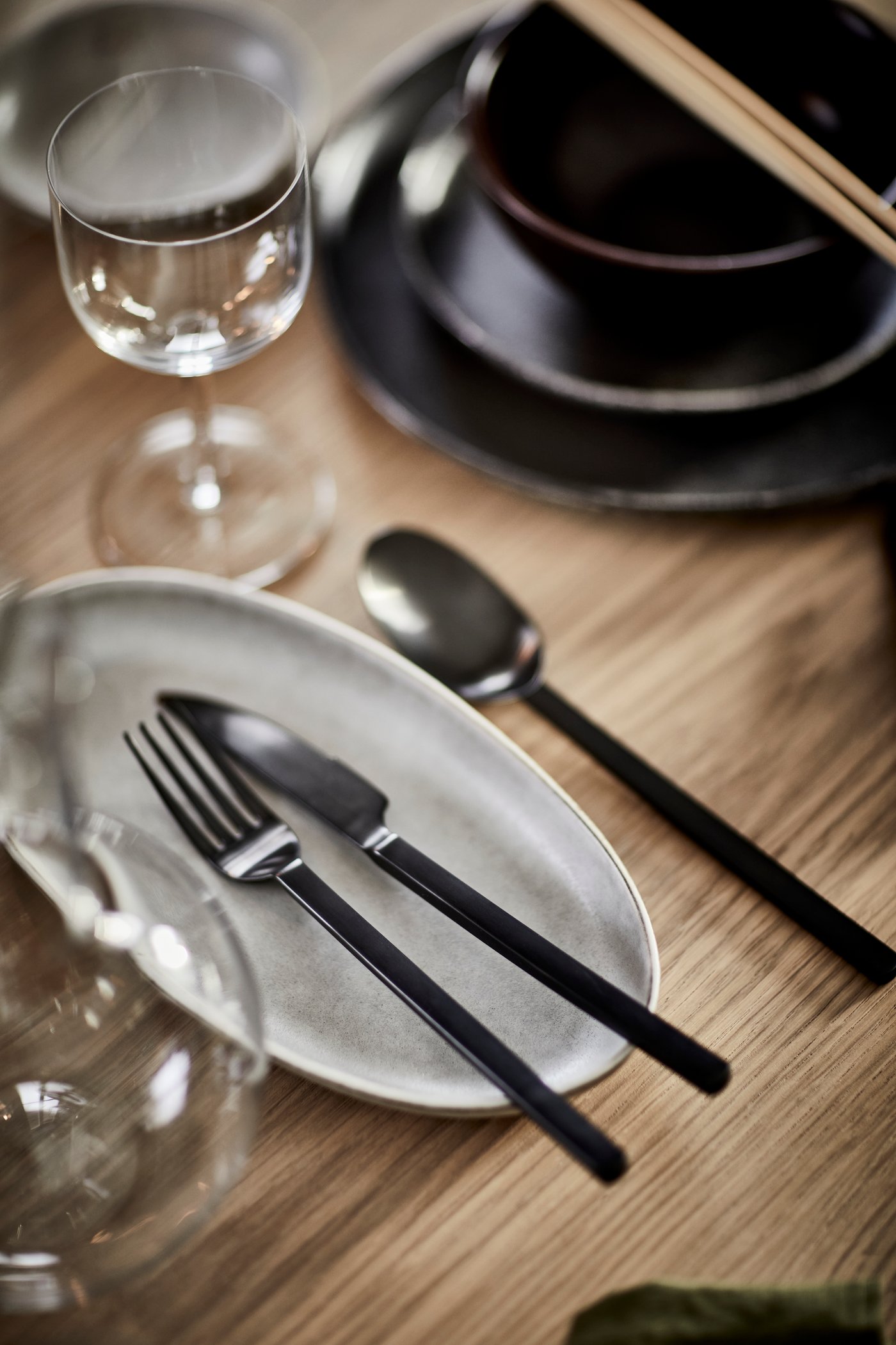Black STOCKHOLM 2025 cutlery on a side plate.