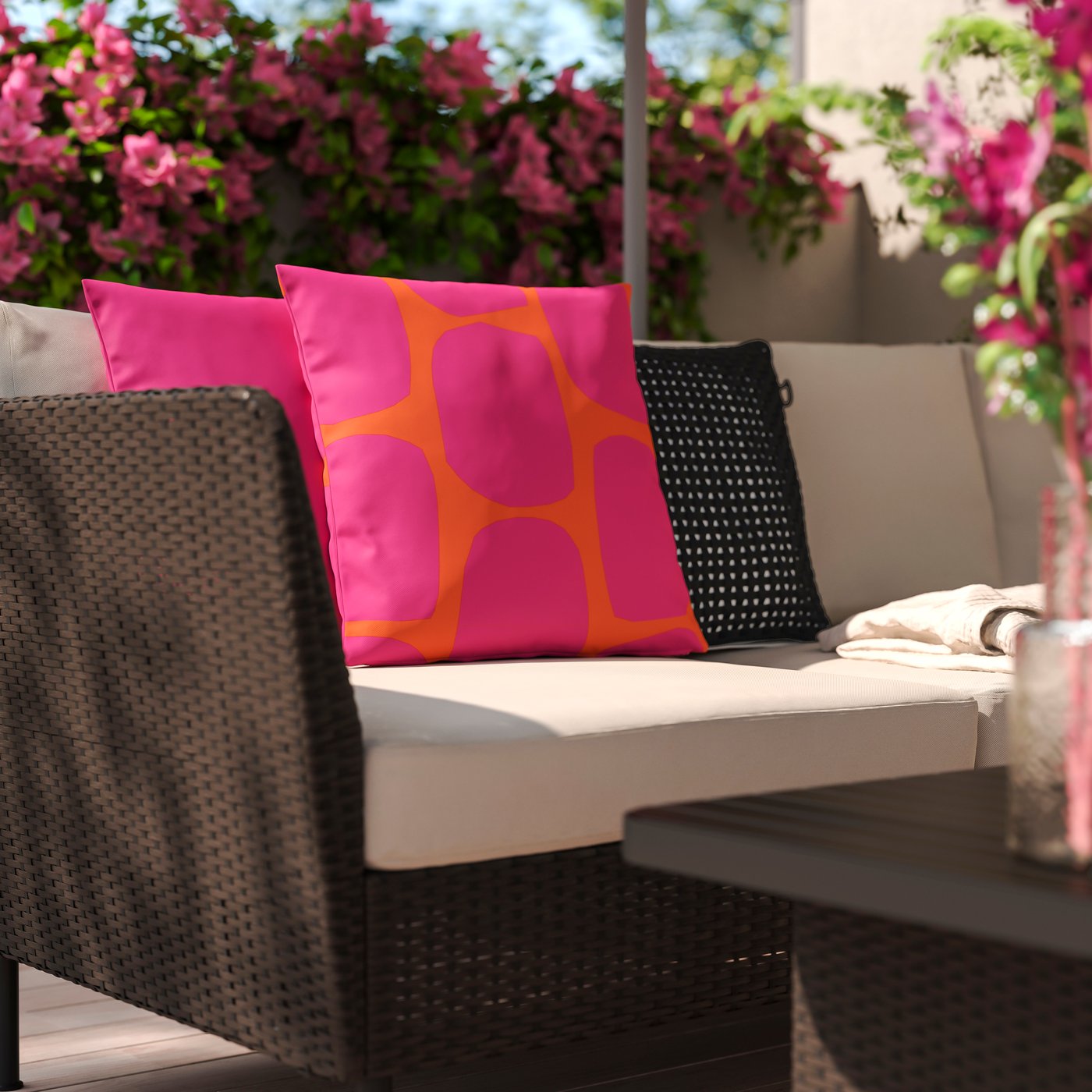 A black outdoor/indoor TOFTÖ cushion cover outside