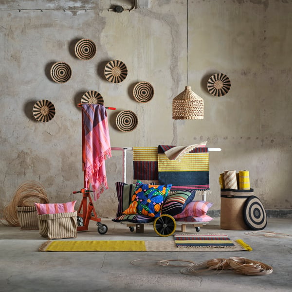 The MÄVINN collection is surrounded by concrete walls and floor. Natural fibres mix with textiles in pink, blue and yellow.