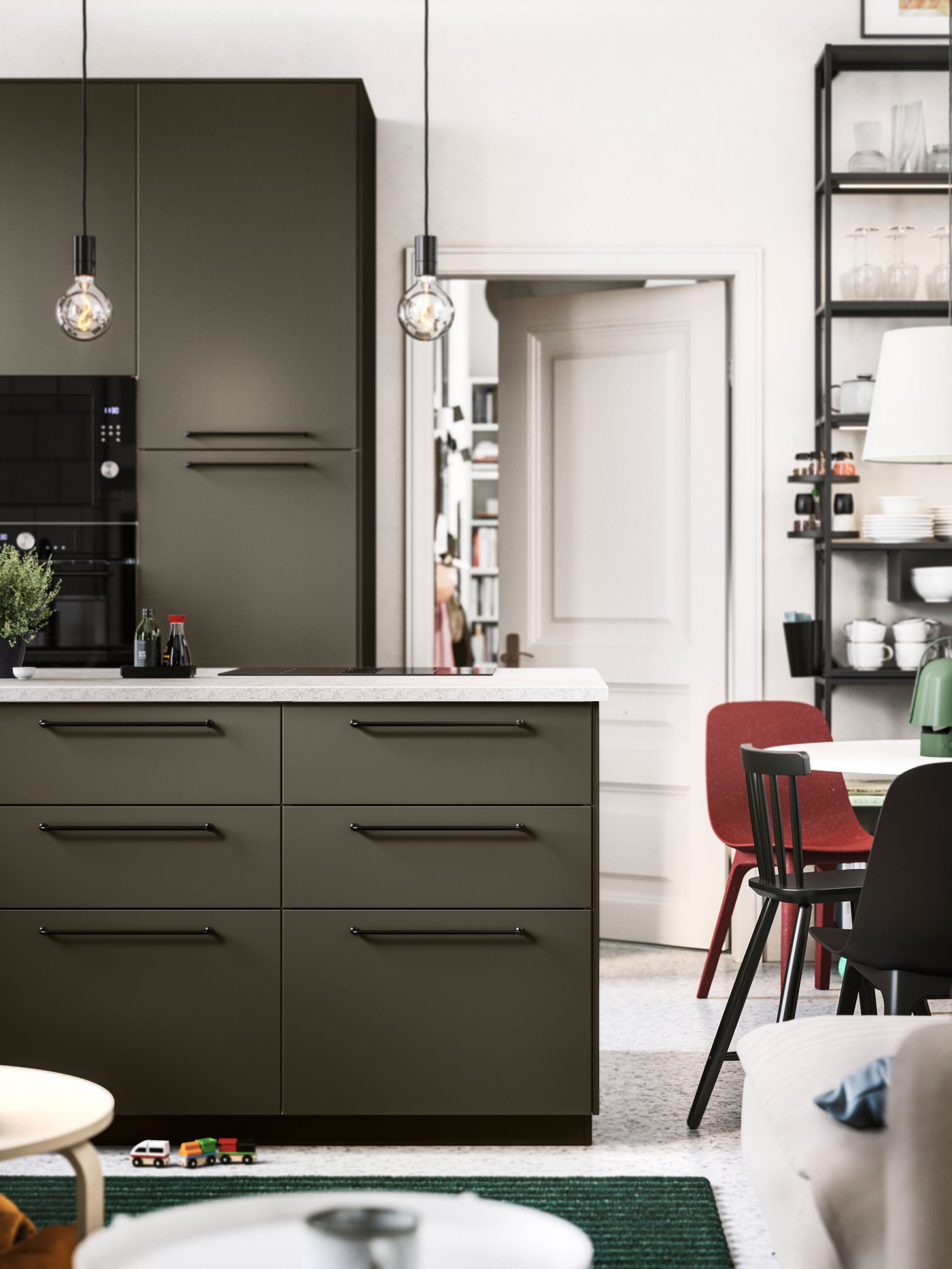 An open kitchen with brown-beige HAVSTORP kitchen fronts, black handles and appliances, and a limestone effect worktop.