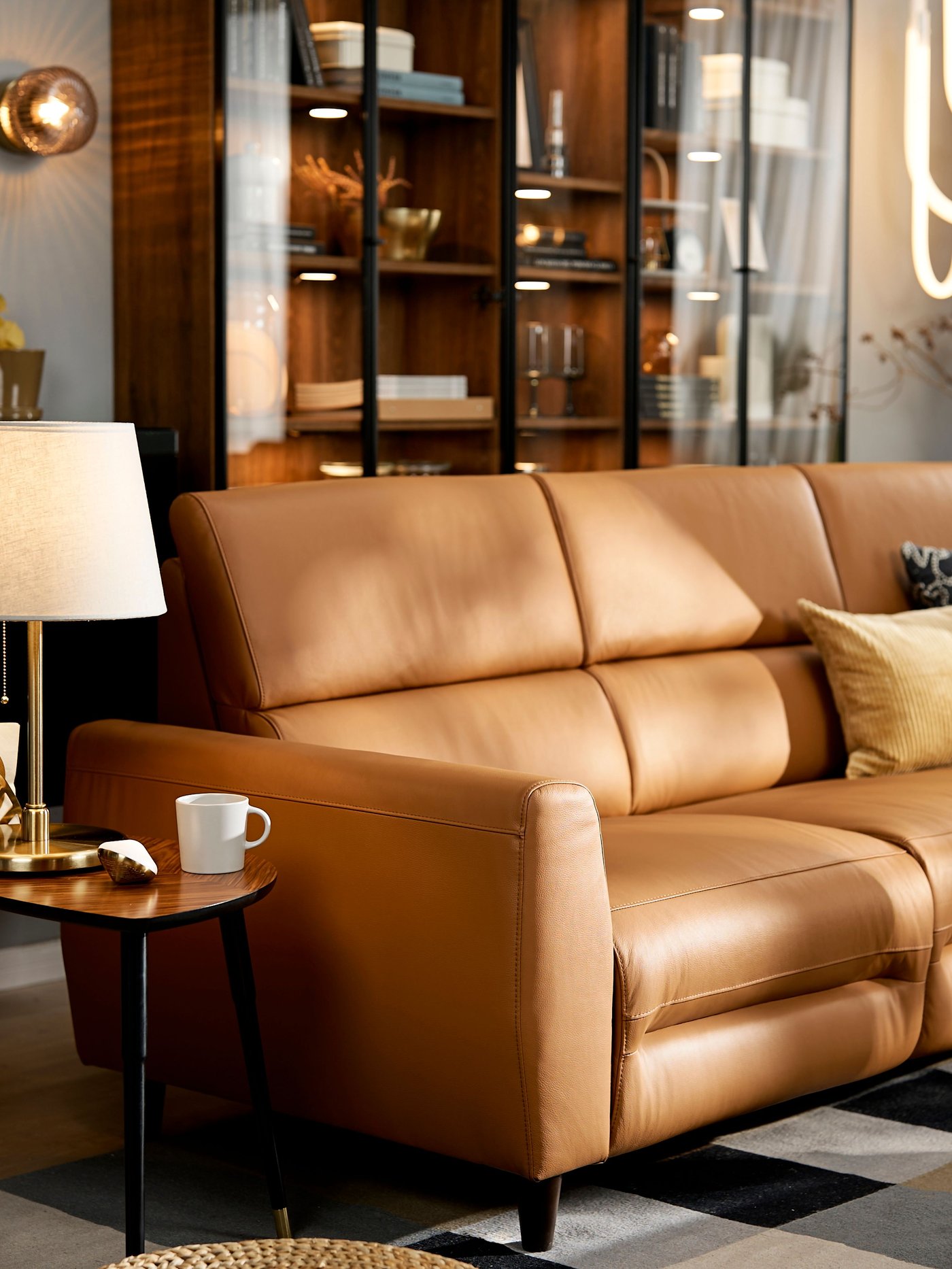A Grann/Bomstad golden-brown RULLERUM 2-seat sofa with electric recliner in the living room