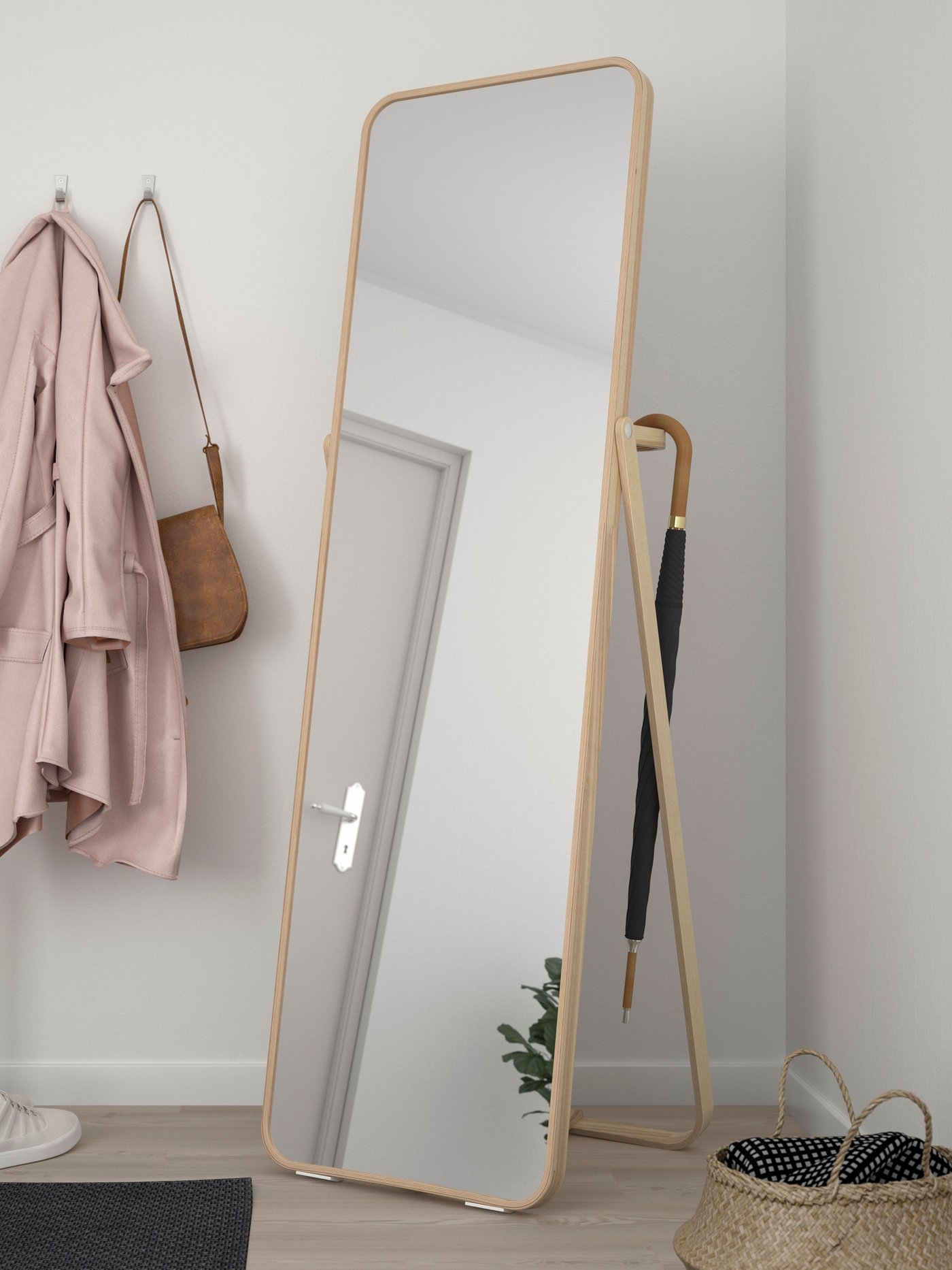 An ash IKORNNES standing mirror in the hallway