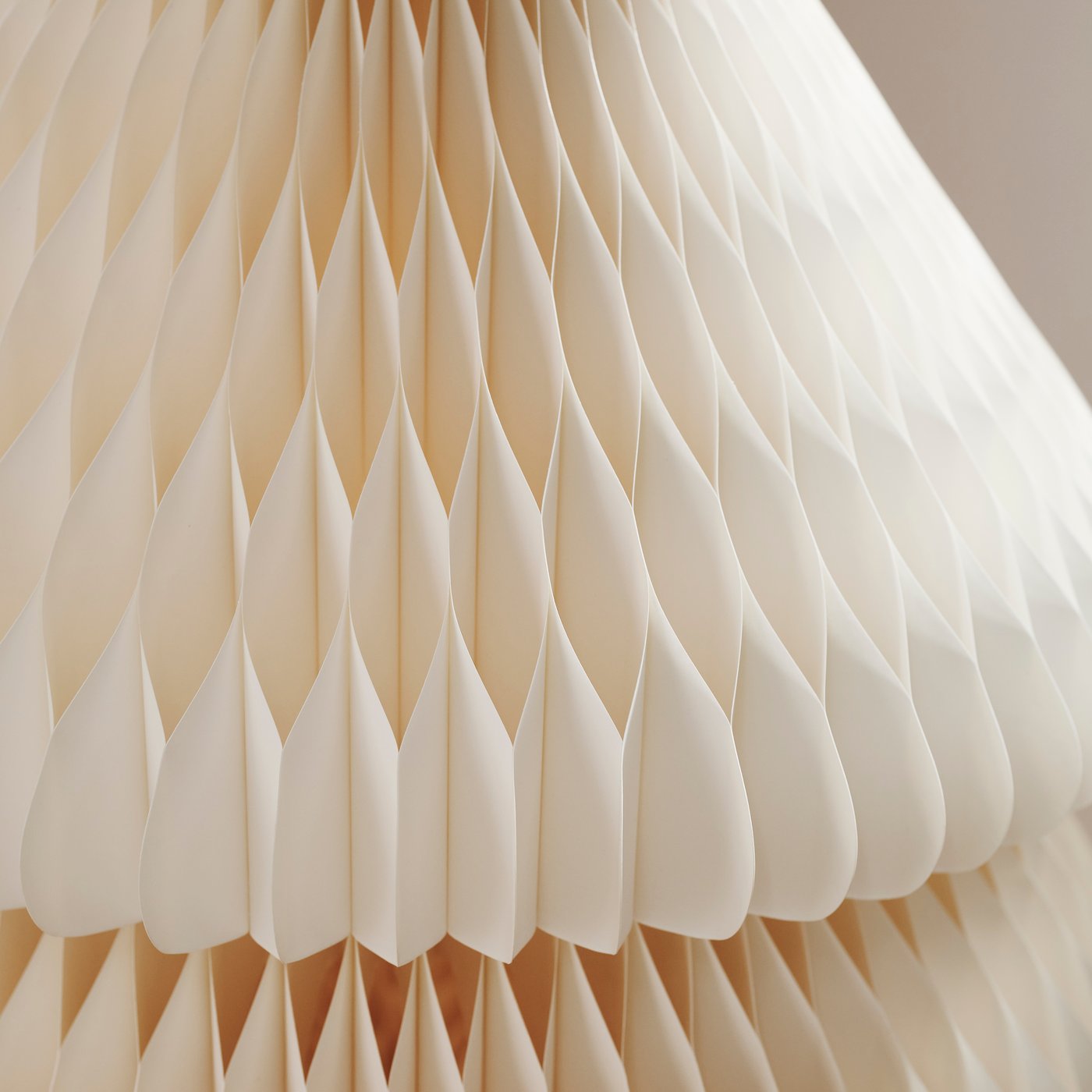 A close-up of a white VINTERFINT paper tree showing the fold and intricate structure of the paper.