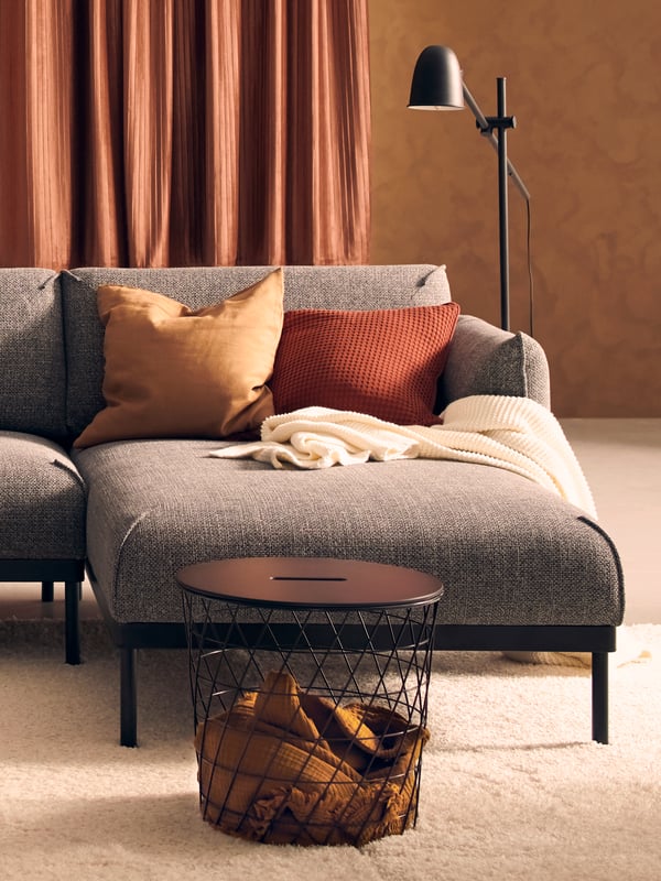 A brown-red VÅRELD cushion cover