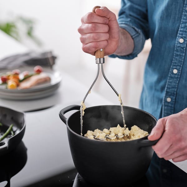A stainless steel/beech VARDAGEN potato masher in the kitchen