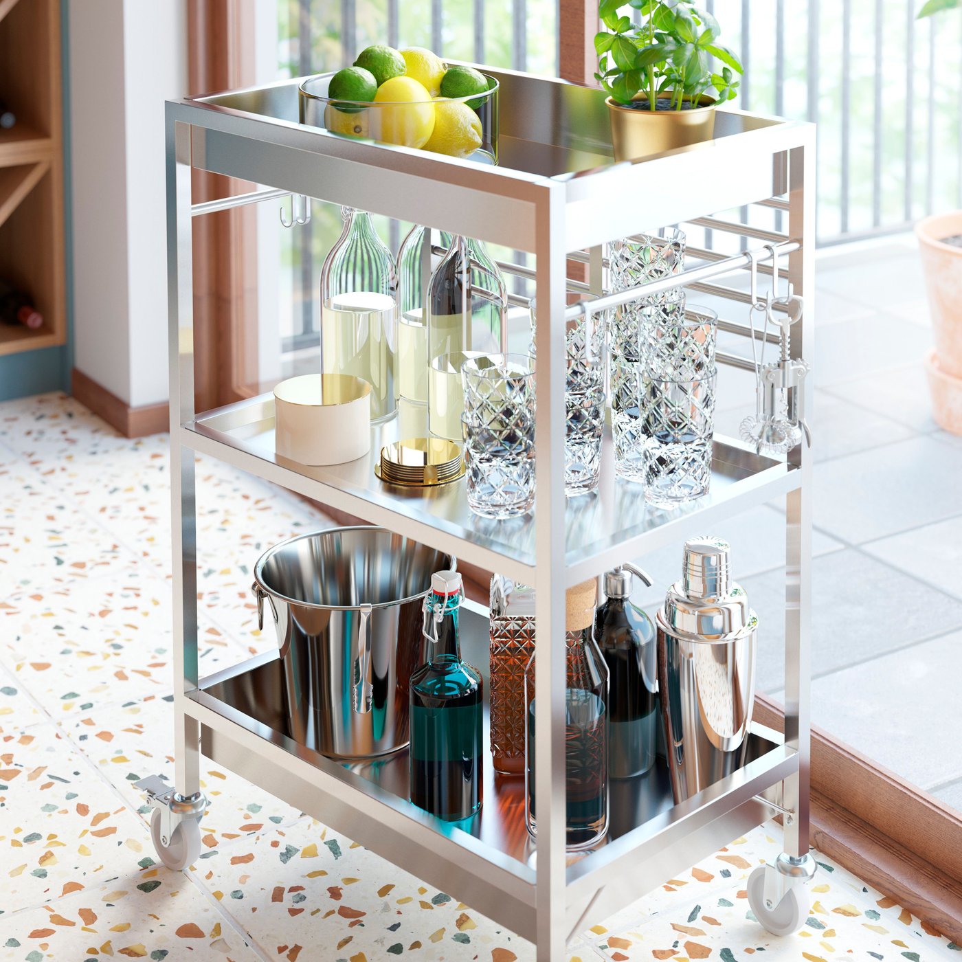 A stainless steel KUNGSFORS kitchen trolley functions as a mini bar cart with drinks is close by a large window.