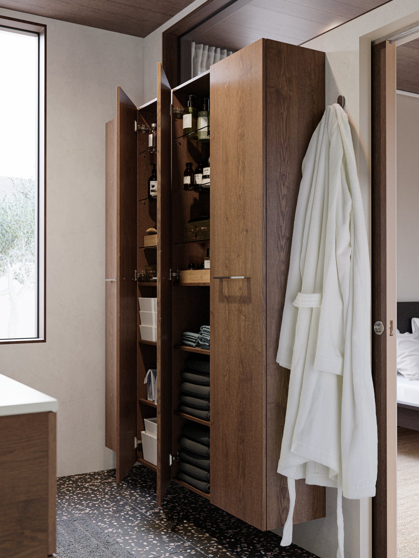 Four high cabinets with wooden doors attached to the wall showing towels, toiletries and boxes arranged in a neat way.
