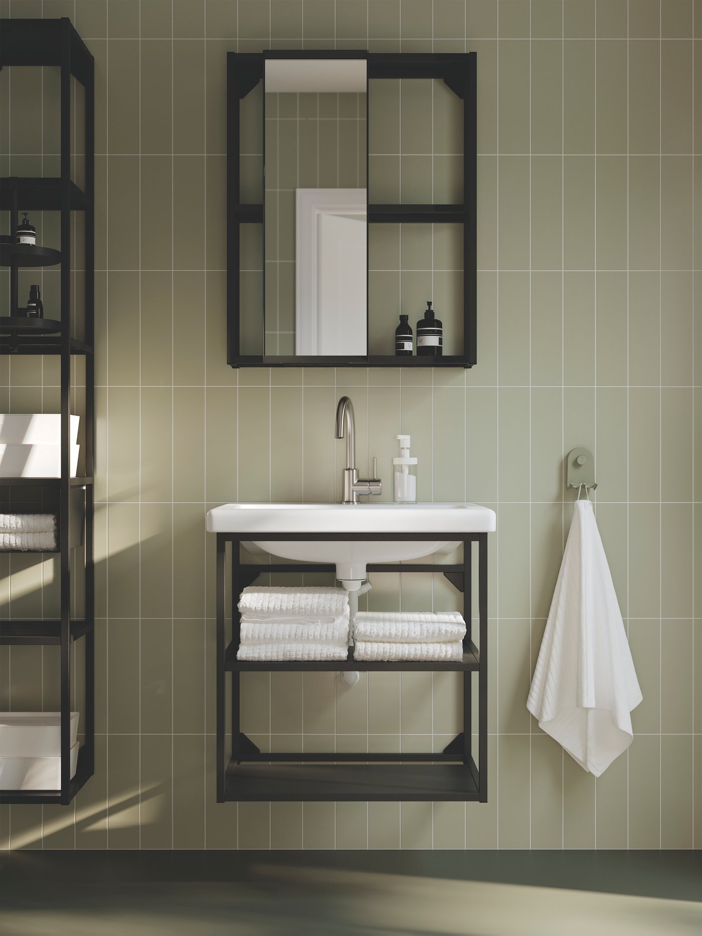 A bathroom has an ENHET open wash-stand with two shelves in anthracite and a TVÄLLEN single wash-basin and a shelving unit.