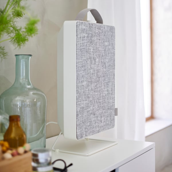 A white FÖRNUFTIG air purifier in the bedroom