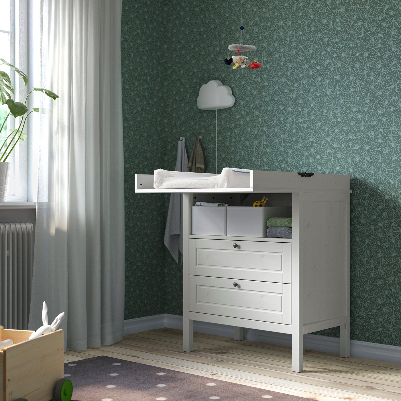 A white changing table in a bedroom.