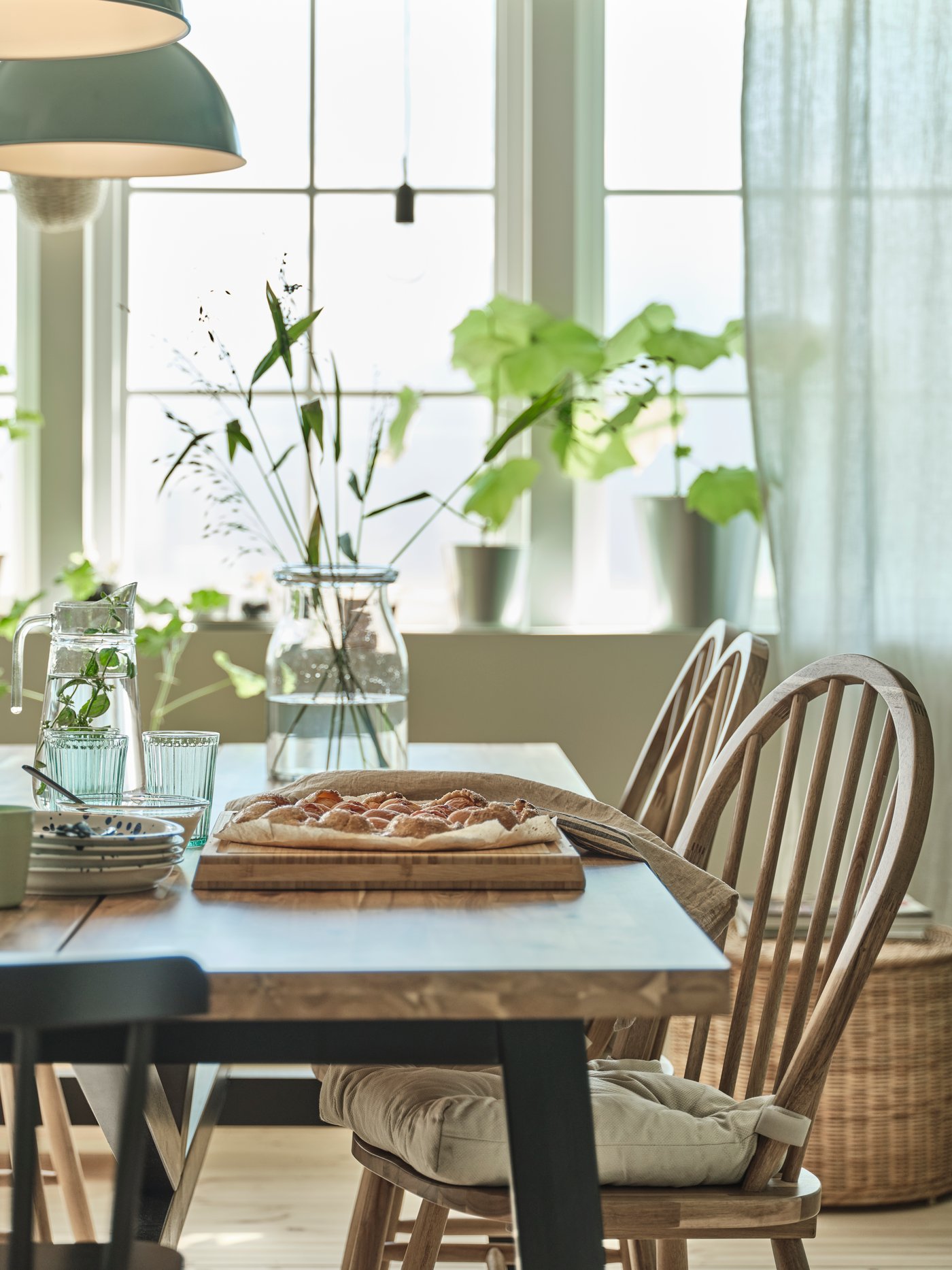 An acacia/black SKOGSTA dining table
