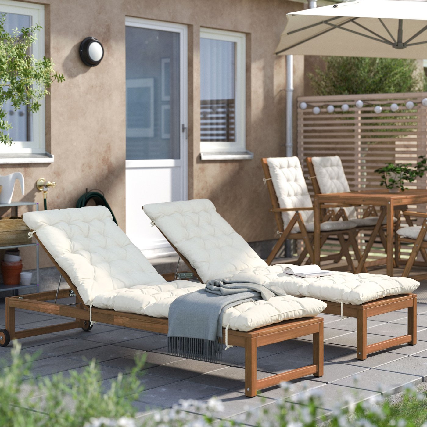 An outdoor light brown stained NÄMMARÖ sun lounger