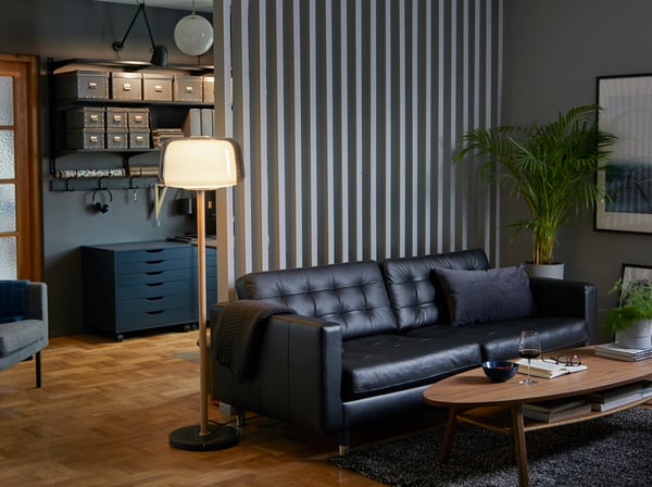 A dark grey FJÄLLA storage box with lid in the living room