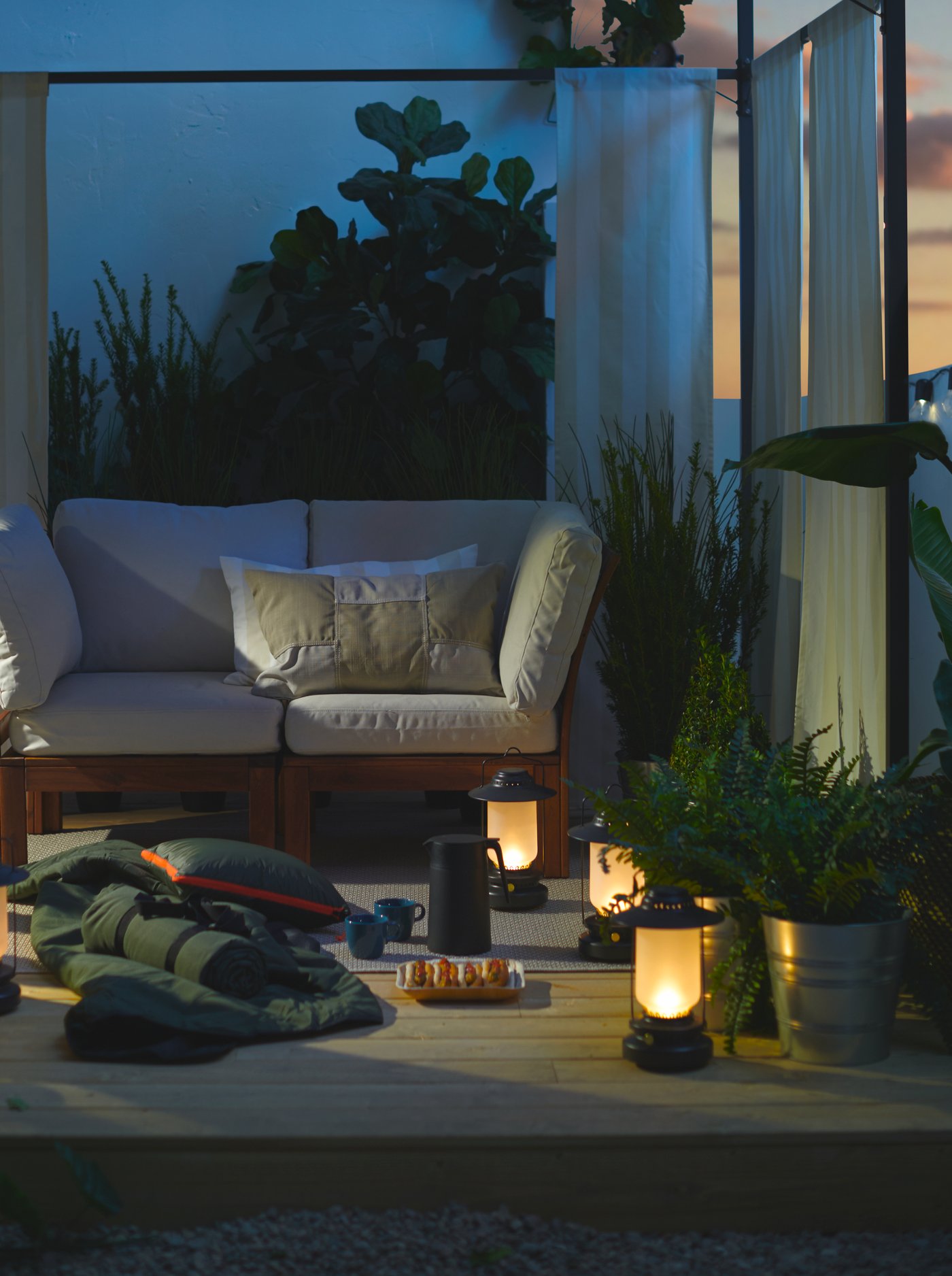 LED lanterns, a blanket, hot dogs and warm drinks under a gazebo on the deck at dusk create a camp-like getaway.
