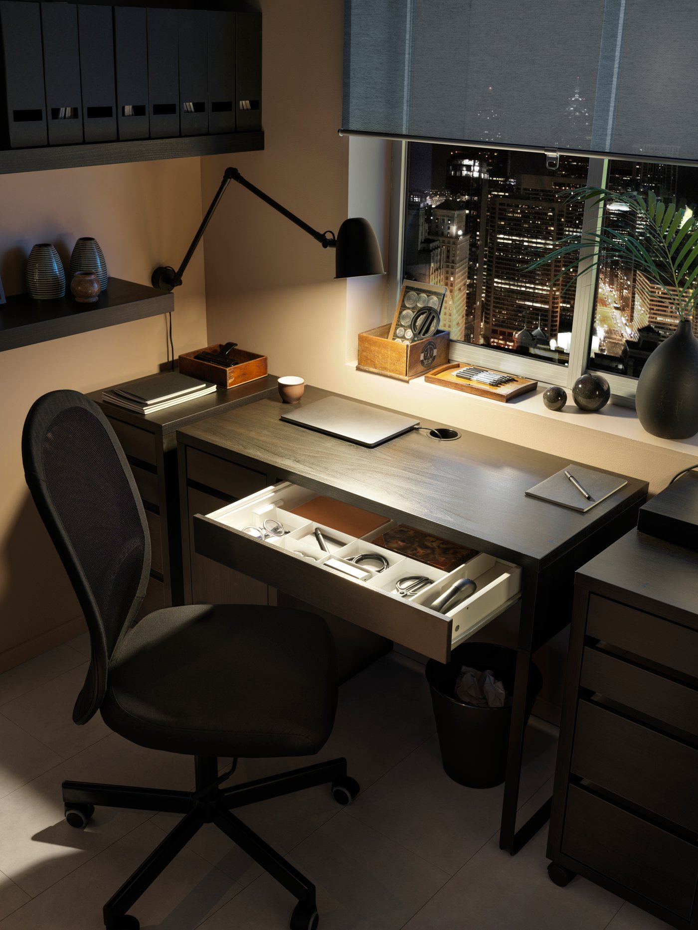 A black TJENA magazine file in the home office