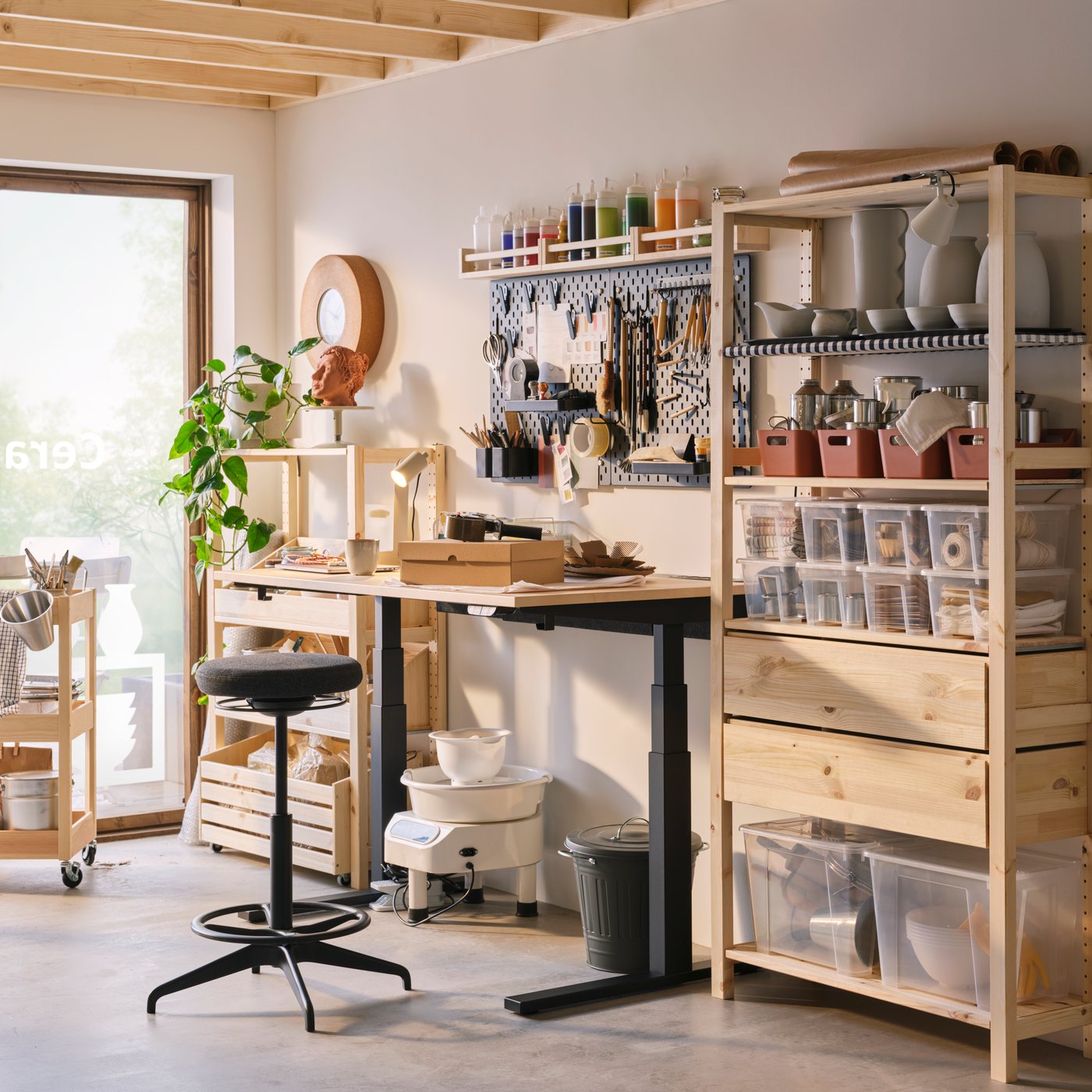 The back office of a shop with a storage and workstation including IVAR shelving, a MITTZON desk and a BEKVÄM spice rack.