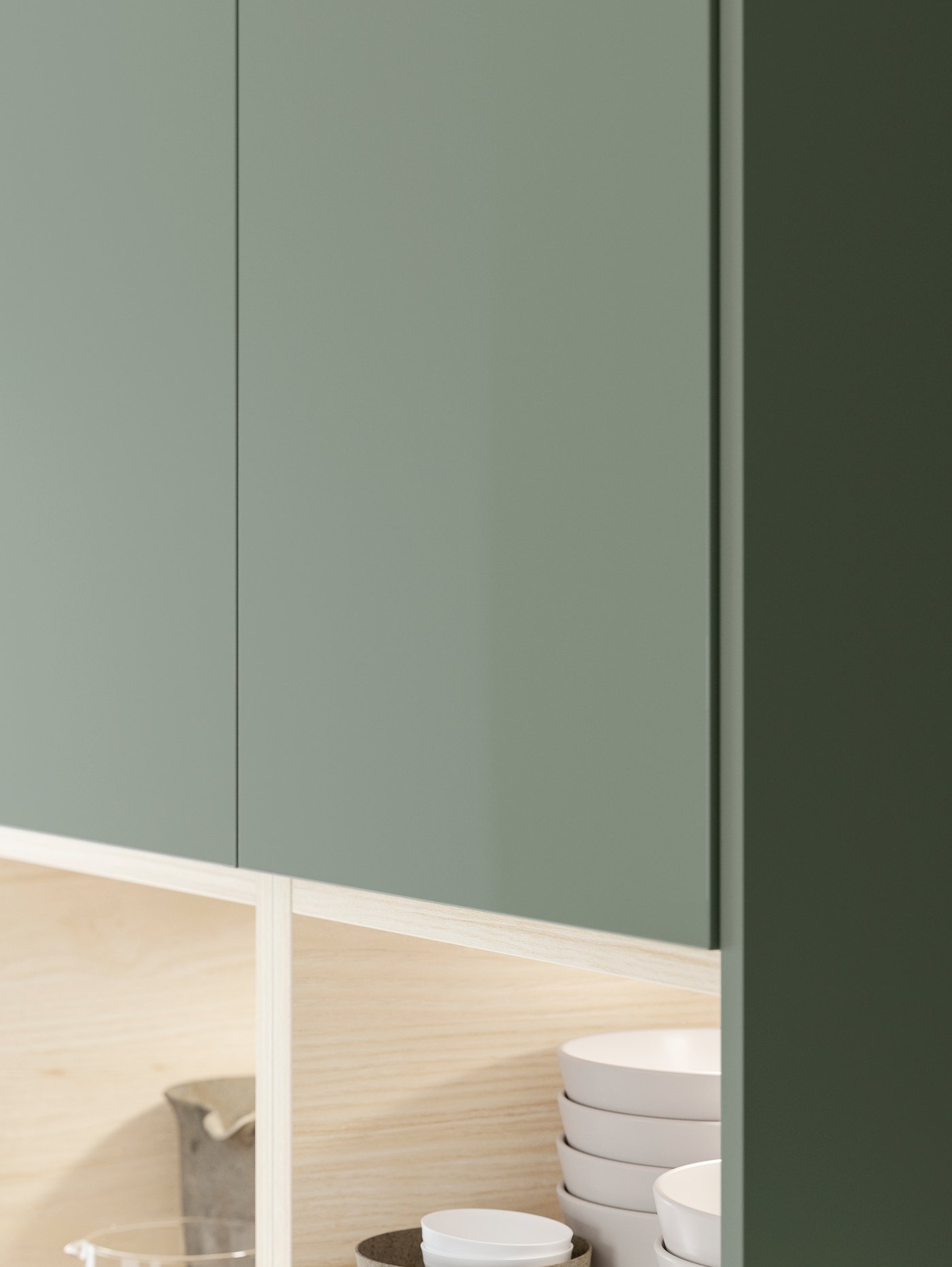 Two BODARP doors in a grey-green foil with lit up open cabinets below storing tableware and more.