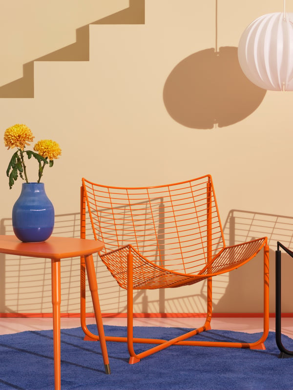 An orange LÖVBACKEN side table