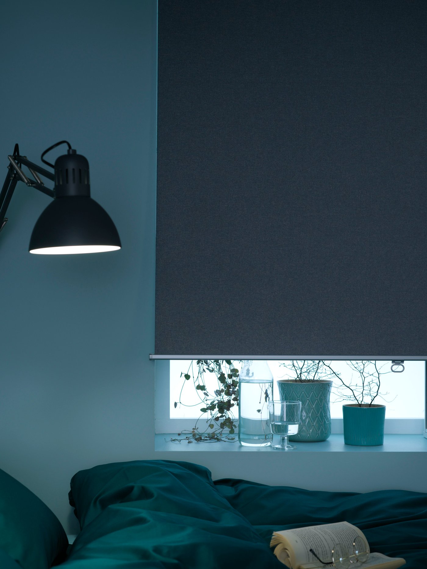 A dark grey TERTIAL work lamp in the bedroom