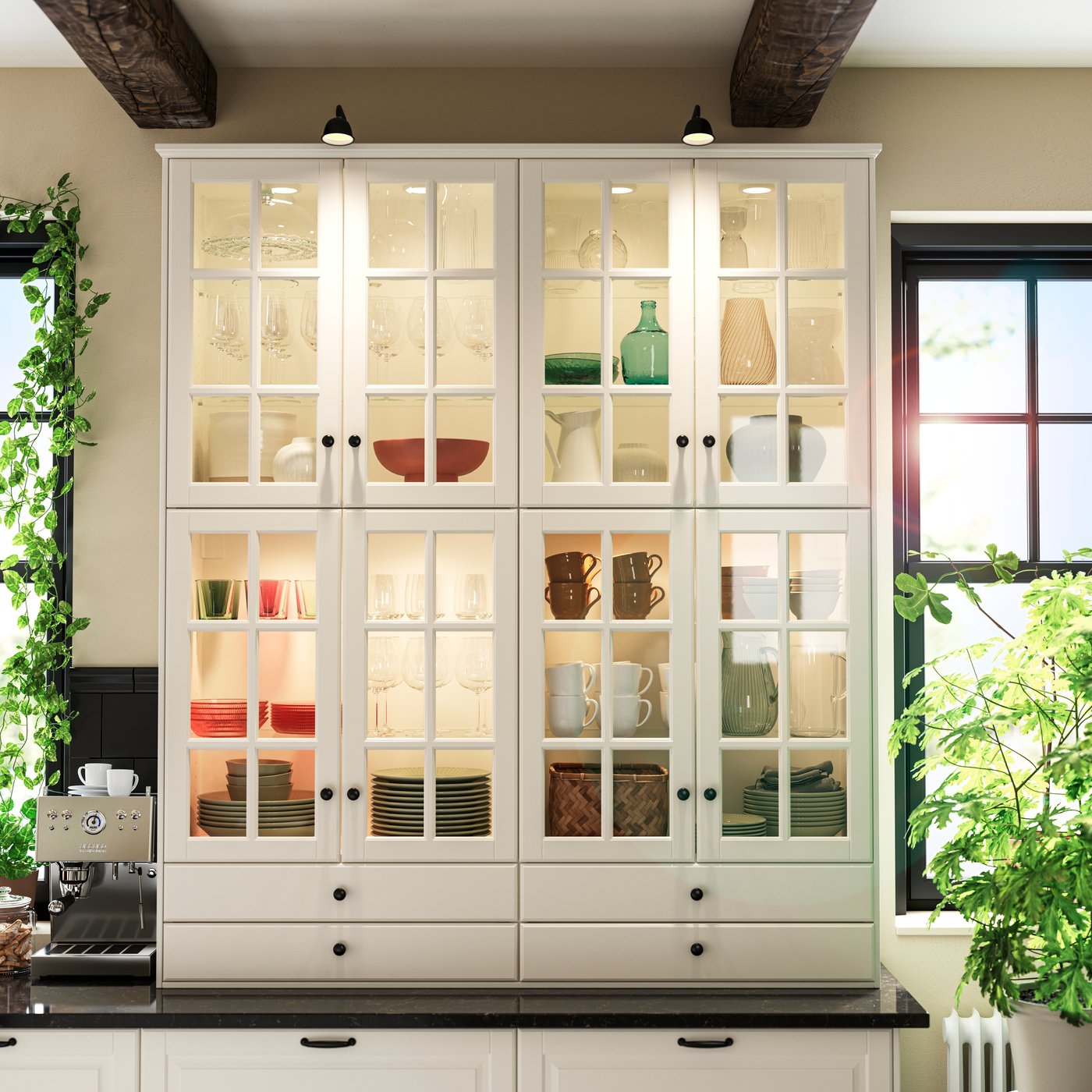 A kitchen with BODBYN kitchen fronts in off-white, glass doors displaying plates, bowls, mugs and glasses inside.