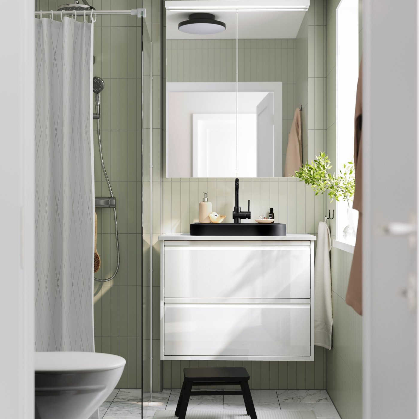 A black BACKSJÖN semi-recessed wash-basin w watr trp in the bathroom