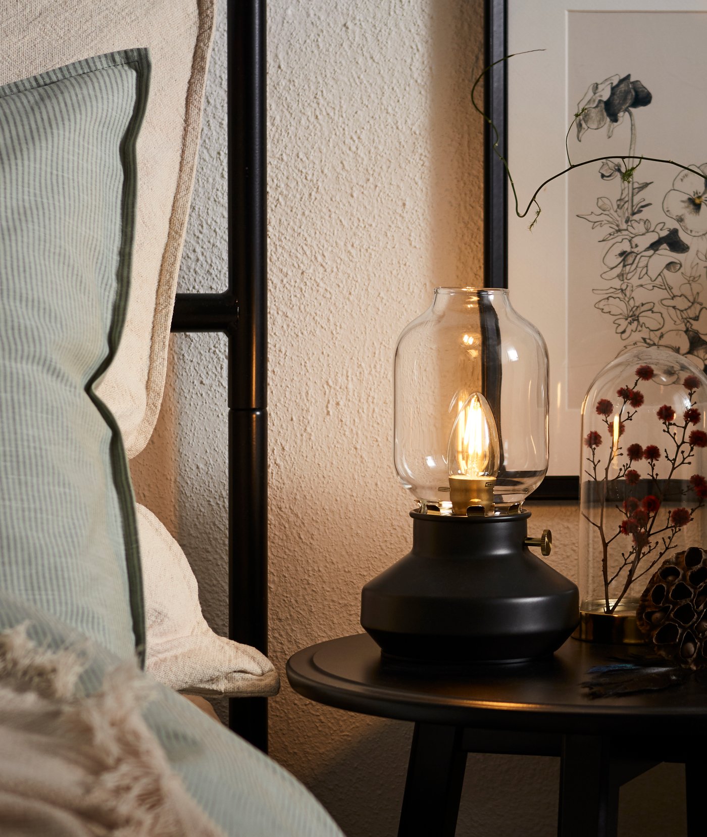 A black KRAGSTA nest of tables in the bedroom