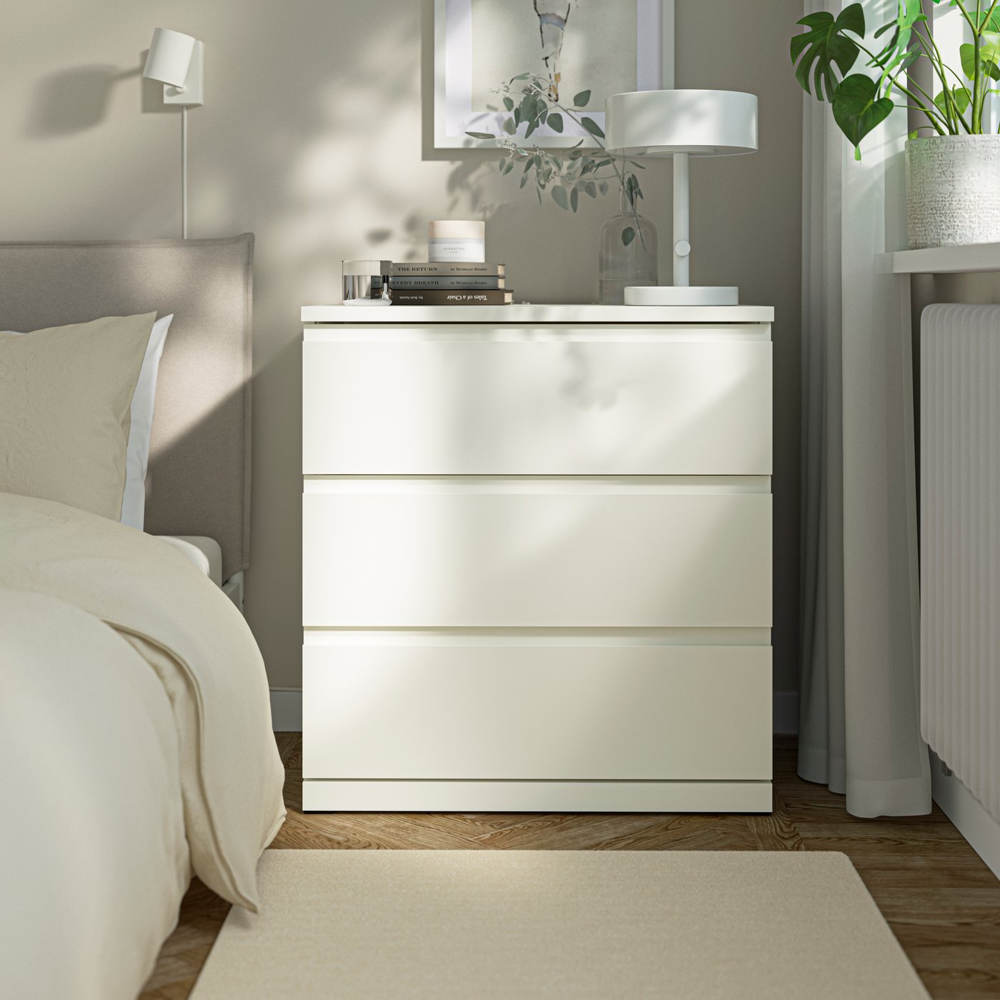 A white STORKLINTA chest of 3 drawers in the bedroom