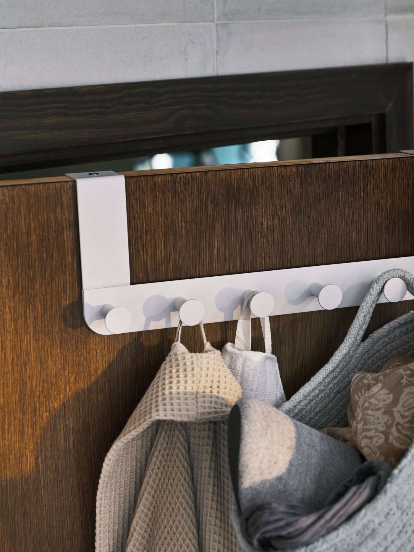 A white ENUDDEN hanger for door in the bathroom