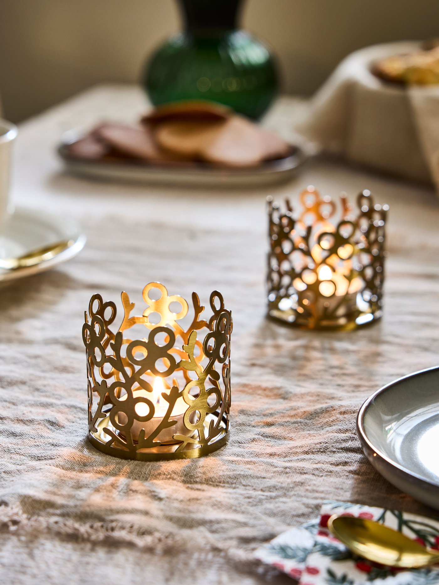 Un portavela de Navidad VINTERFINT dorado sobre una mesa.