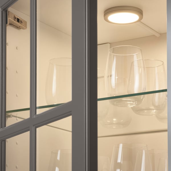 MITTLED spotlight in a wall cabinet with a glass door