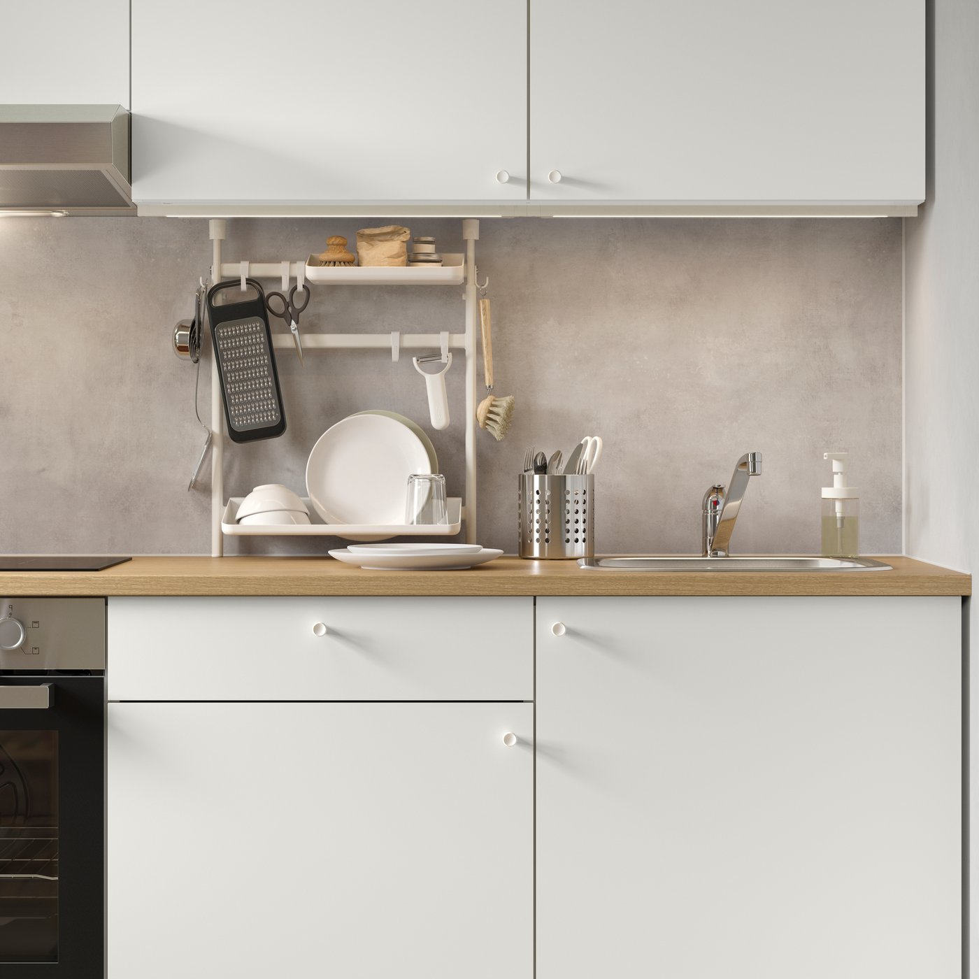 A stylish white KNOXHULT base cabinet featuring a drawer and doors, set against a grey concrete wall in a modern kitchen.