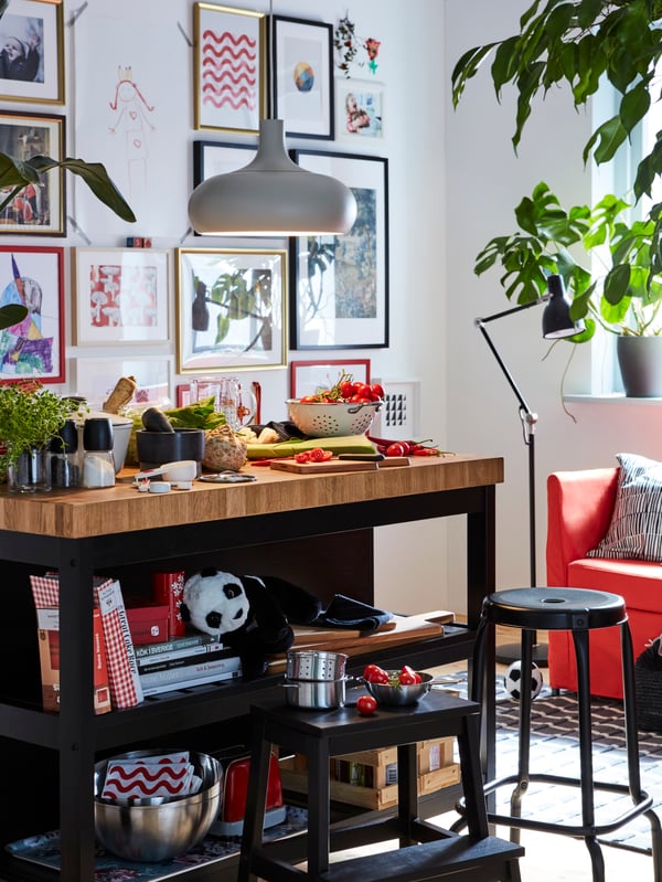 A black/oak VADHOLMA kitchen island in the kitchen