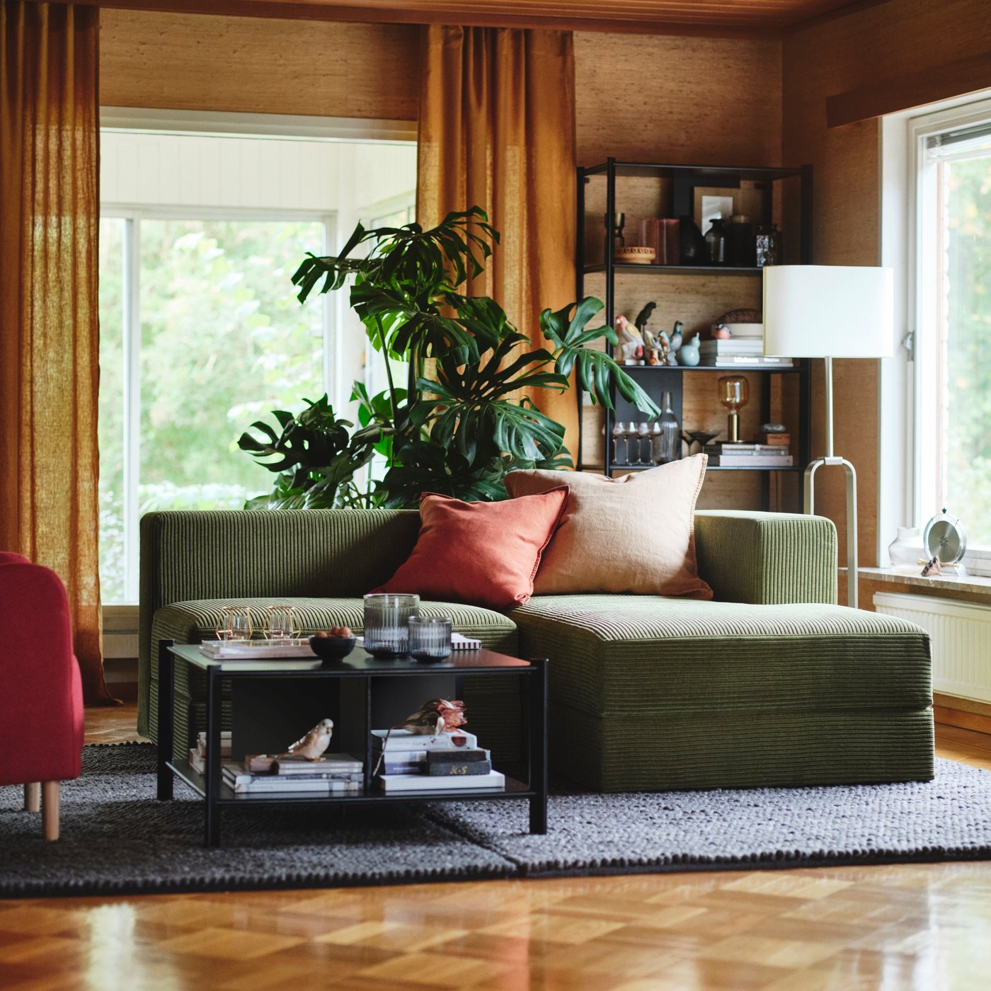 A green JÄTTEBO sofa in the living room.