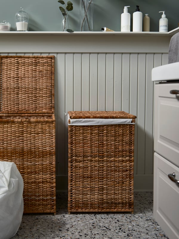 Two BRANÄS rattan laundry baskets with lining. One basket is open, and its lining with laundry inside stands next to it.