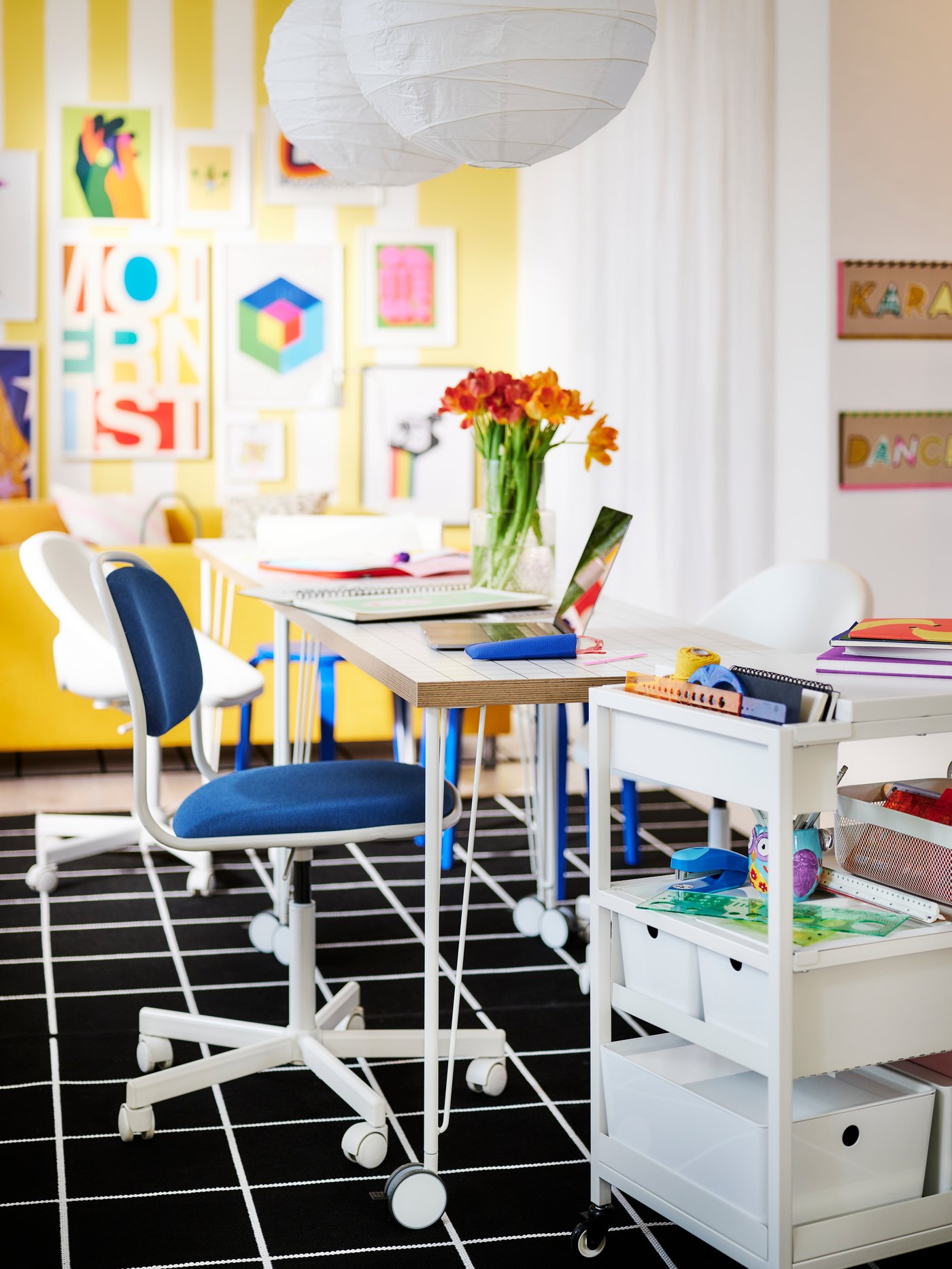 A room filled with a desk, papers and a chair.