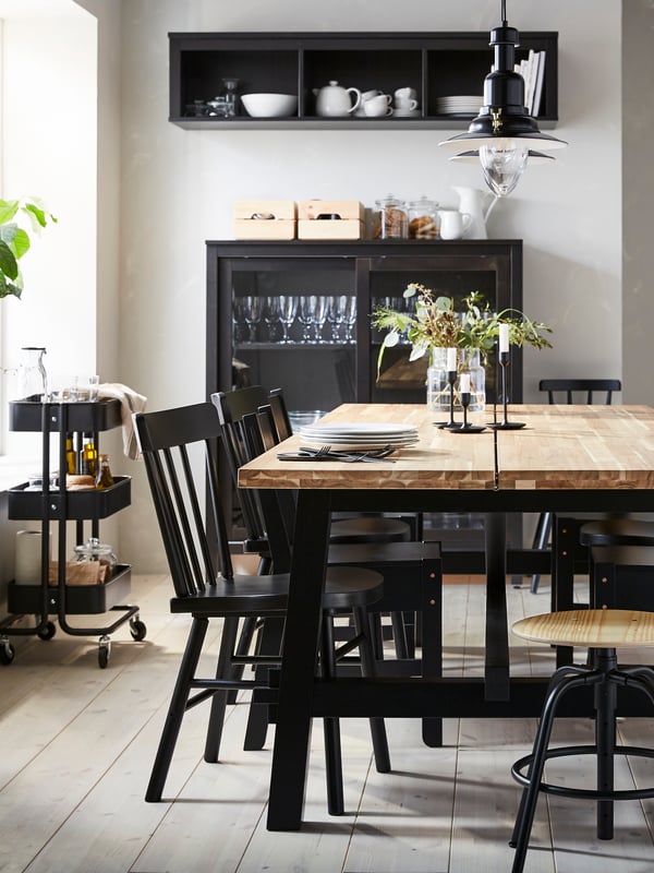 An acacia/black SKOGSTA dining table in the dining room