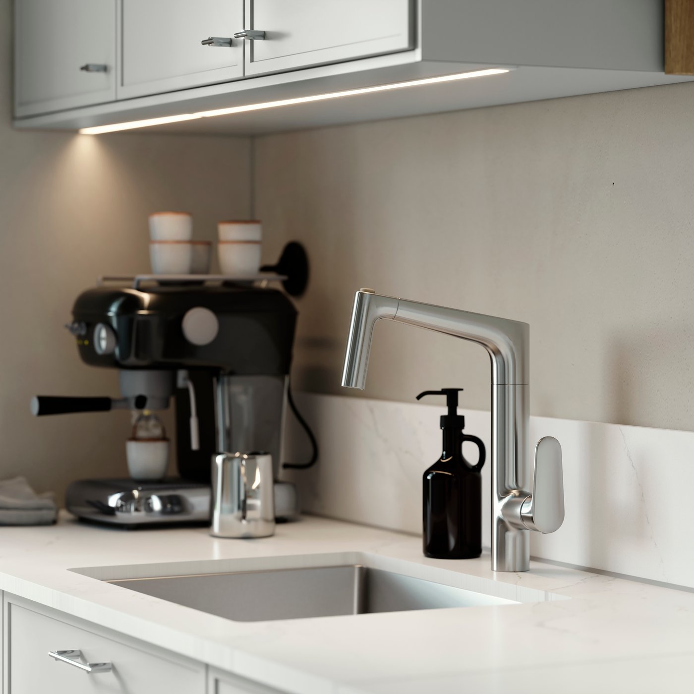 MAJSJÖN kitchen mixer tap pull out with spray, placed above a sink with white worktop and black soap dispenser.