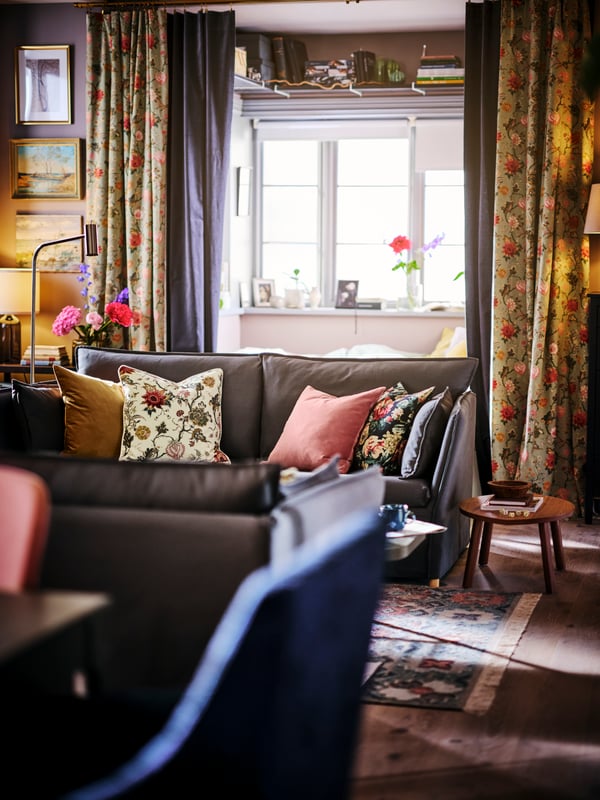 Two grey BACKSÄLEN sofas facing one another, with a STOCKHOLM nesting table to the side and a bay window behind.
