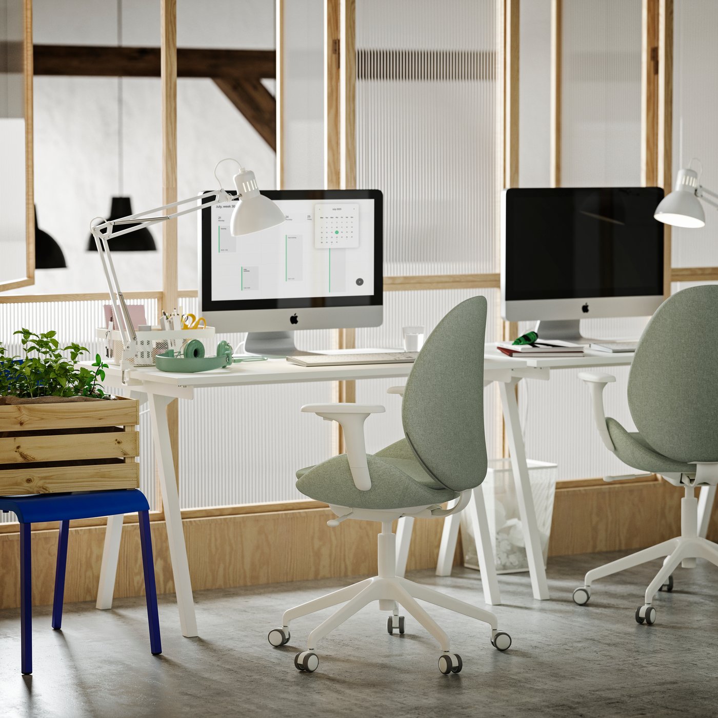 A small office with two white TROTTEN desks, light green/white HATTEFJÄLL conference chairs and white TERTIAL work lamps.