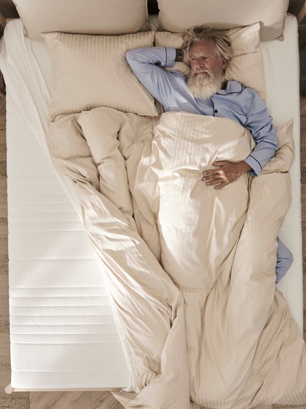 A firm/white ÅNNELAND hybrid mattress
