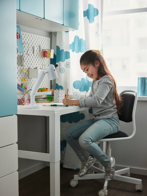 A child working on a PÅHL desk.