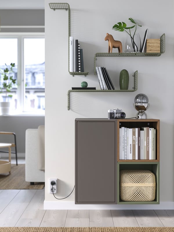 Living room with SVENSHULT wall shelf in grey-green displayed on the wall.