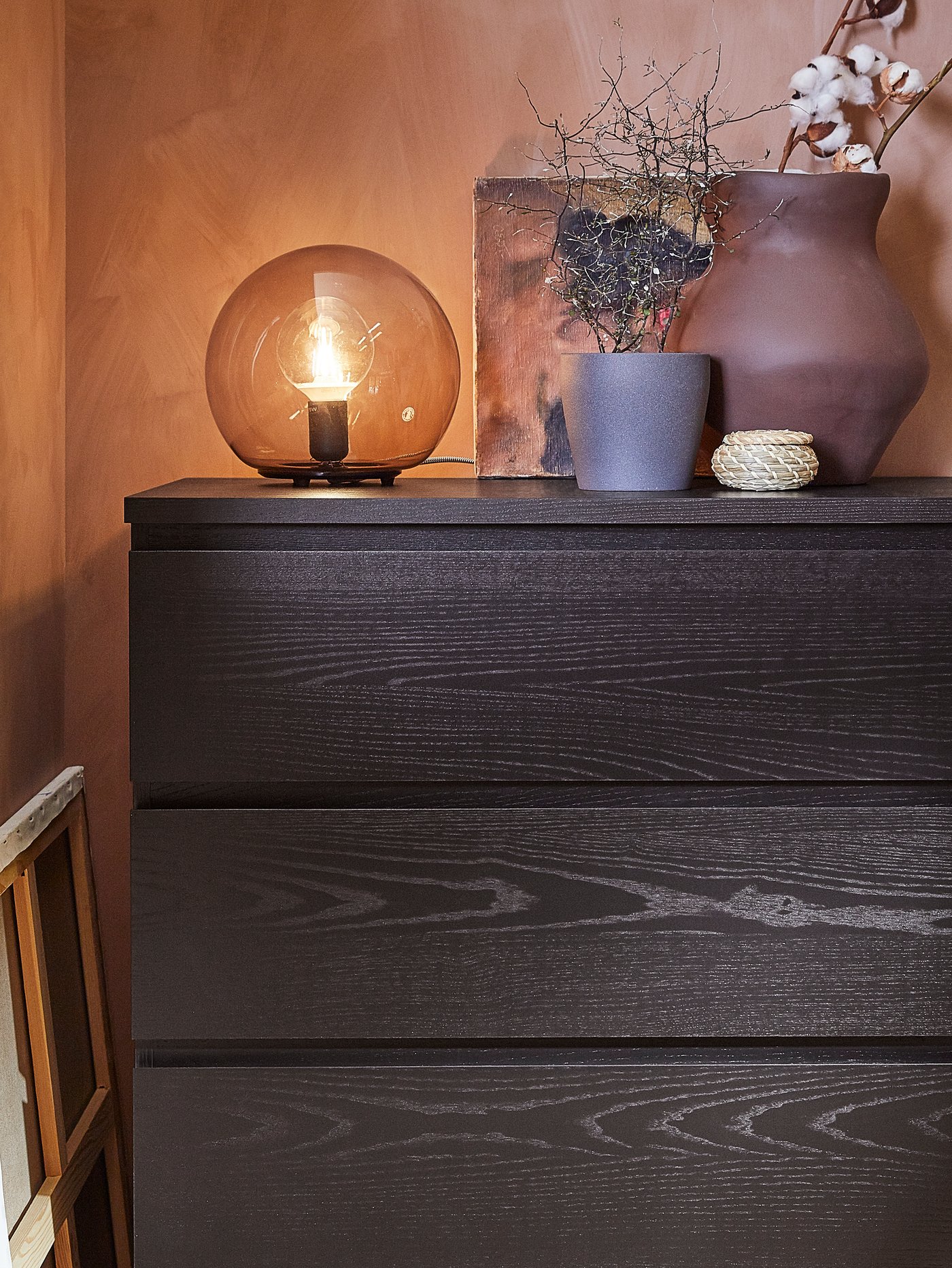 A black-brown MALM chest of 4 drawers in the bedroom